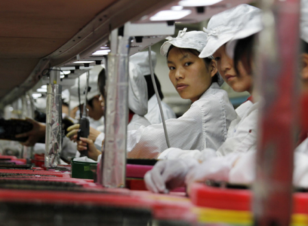 Workers are seen inside a Foxconn factory in the township of Longhua in the southern Guangdong province May 26, 2010. A spate of nine employee deaths at global contract electronics manufacturer Foxconn, Apple's main supplier of iPhones, has cast a spotlight on some of the harsher aspects of blue-collar life on the Chinese factory floor. REUTERS/Bobby Yip (CHINA - Tags: BUSINESS EMPLOYMENT)